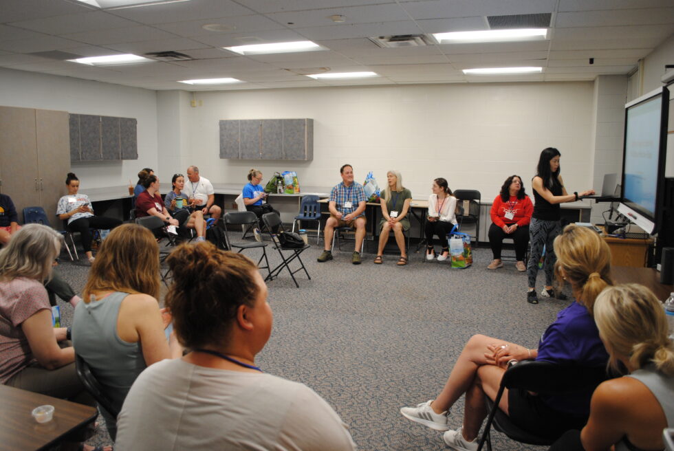 A diverse group in a circle discussion in a classroom.
